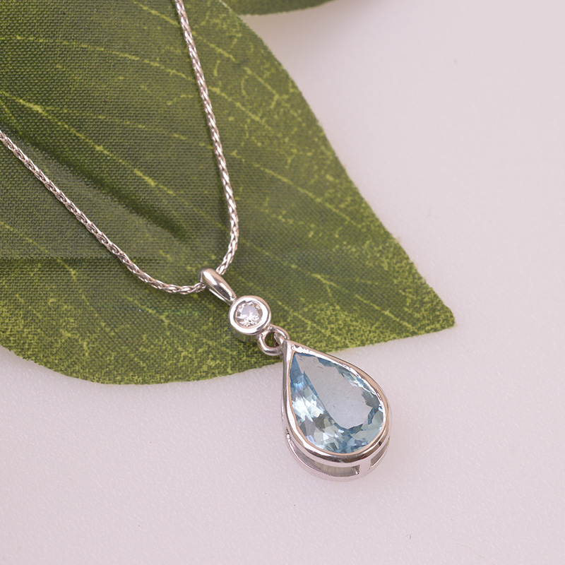 Pear Shape Aquamarine and Small Round Diamond set in 9ct White Gold with Chain