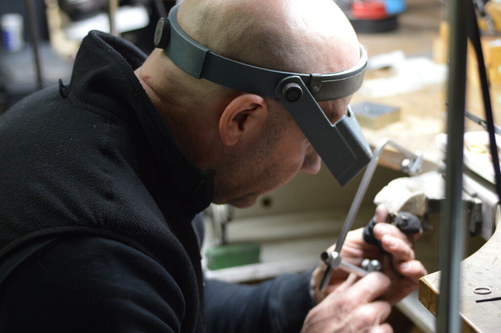 Lee working on jewellery bench
